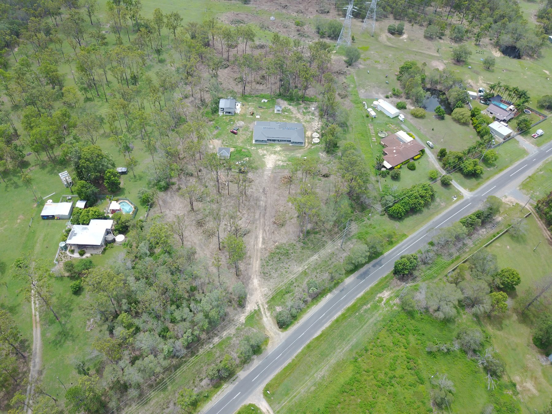 Aerial view of a development block cleared by Tree Eaters beside the road