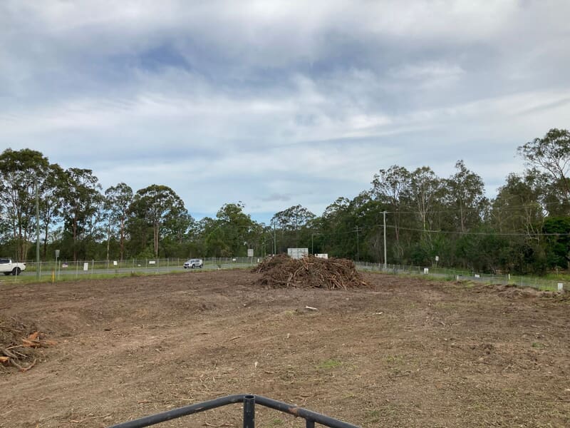 Wide view of the cleared Old Pub Lane block with residue piled clear of the road