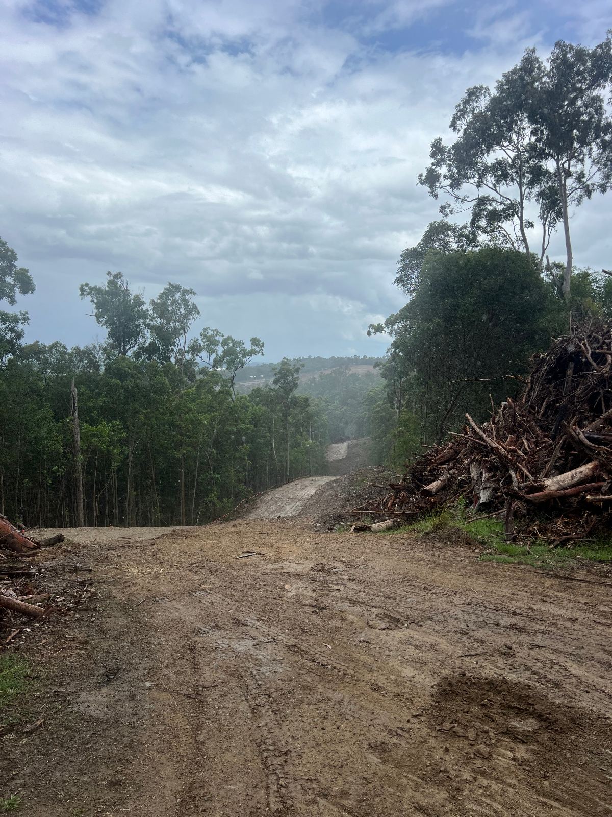 Cleared pipeline corridor running over a ridge with residue stacked to one side