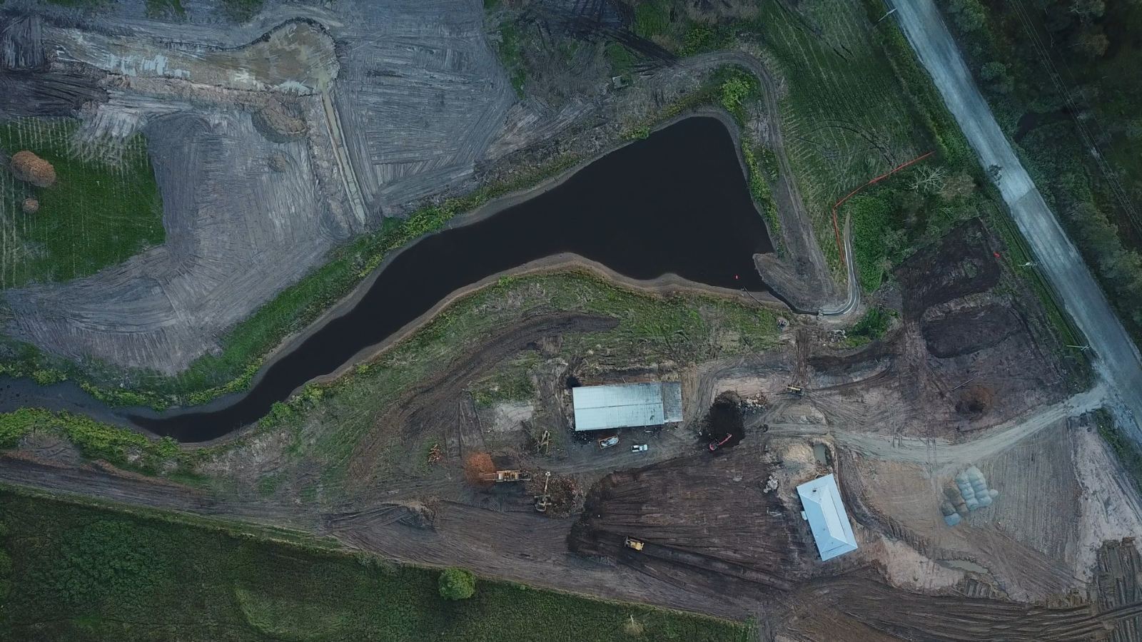 Overhead view of the cleared Stockleigh site showing stick-raked ground and dam