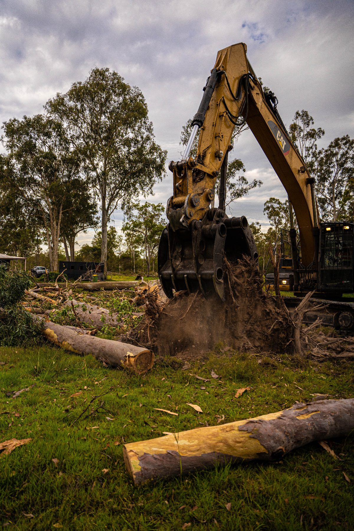 Grapple removing a stump and root ball